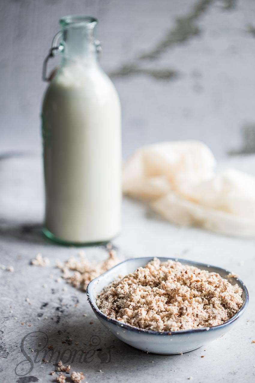 Bottle of almond milk with ground almonds 