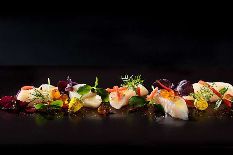 Pretty fish dish against a black backdrop with artificial light | insimoneskitchen.com