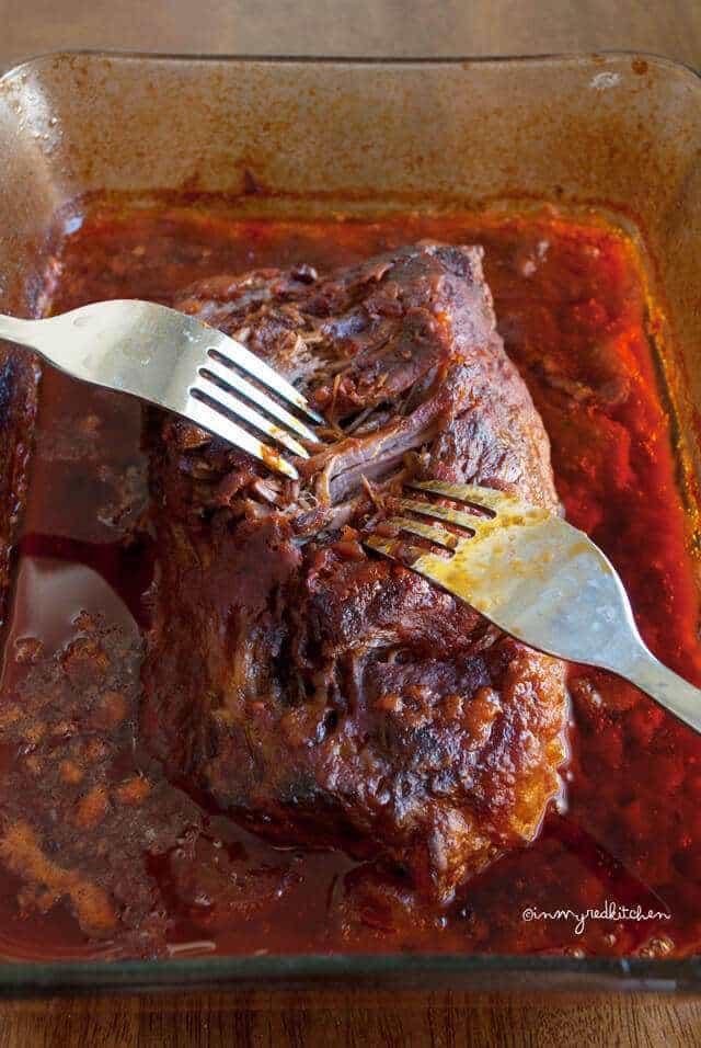 Pulling the beef apart with two forks