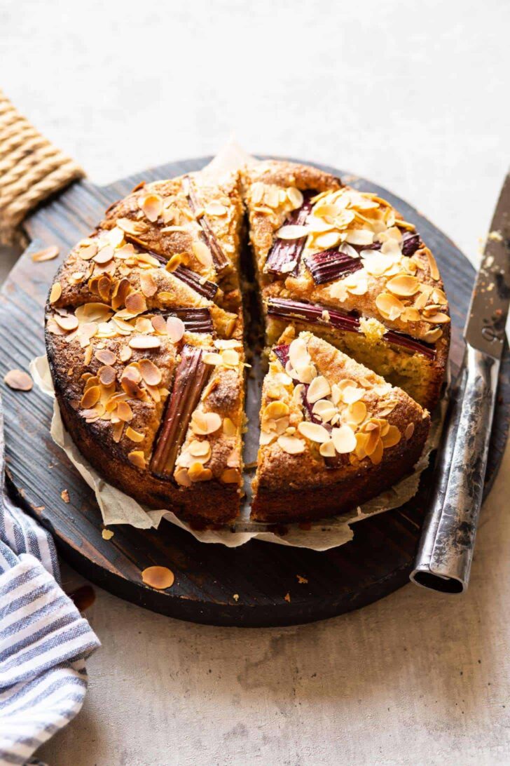 rhubarb cake sliced in pieces on wooden board