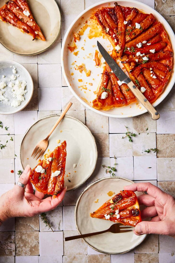 carrot tarte tatin with hands grabbing a piece