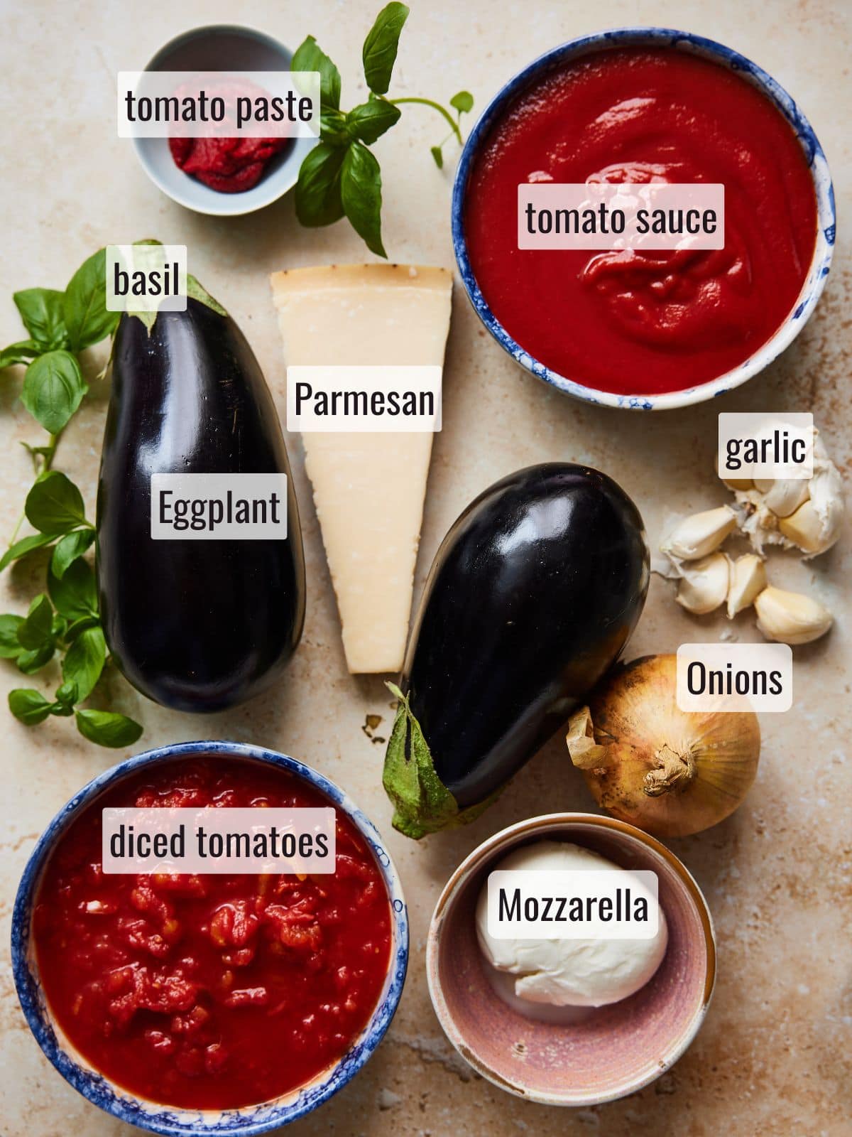 Eggplant parmigiana ingredients laid out on a stone table