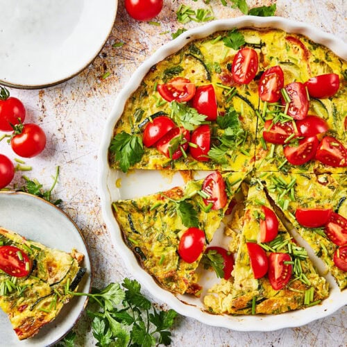 Zucchini quiche in quiche form with plate